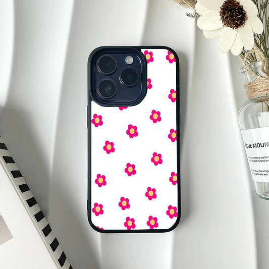White phone case with a sparse, minimalist pattern of small bright pink flowers with yellow centers.